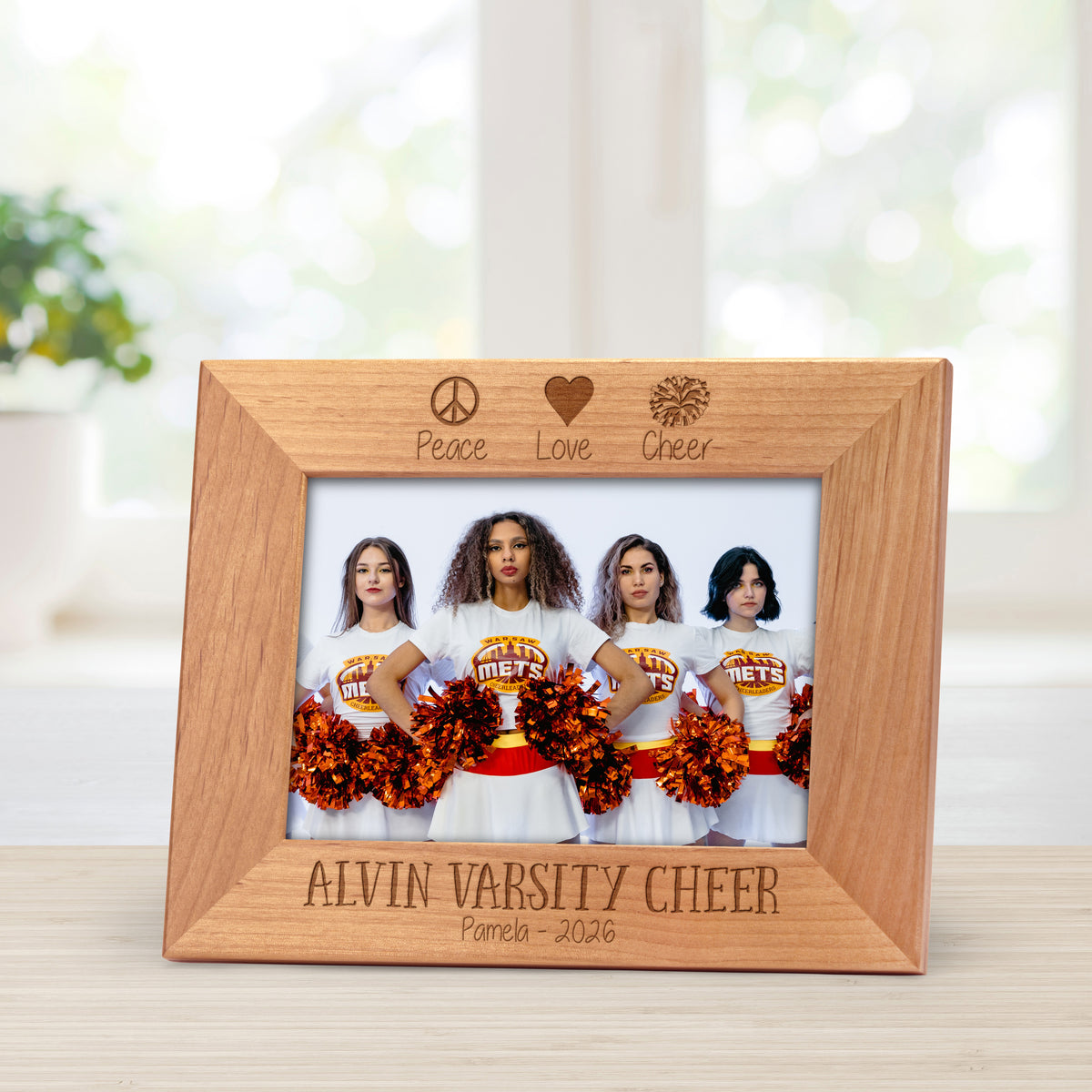 Cheerleading picture frame engraved with the words peace, love, cheer at the top.