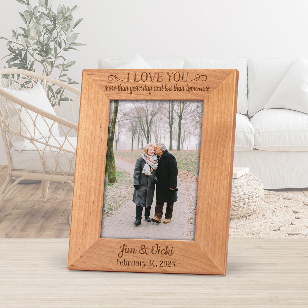 Wooden anniversary picture frame engraved with a saying and personalized with names and date.