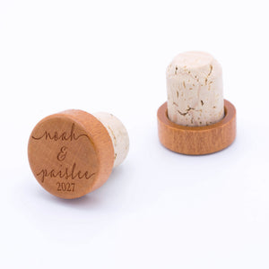 Personalized cork wine stoppers engraved with a couple's names and custom date.