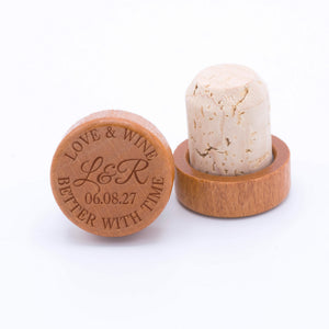 Personalized wine bottle stoppers engraved with the design, "Love & Wine Better with Time".