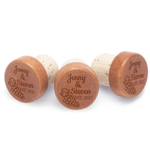 Personalized bottle stoppers engraved with couple's names and date.