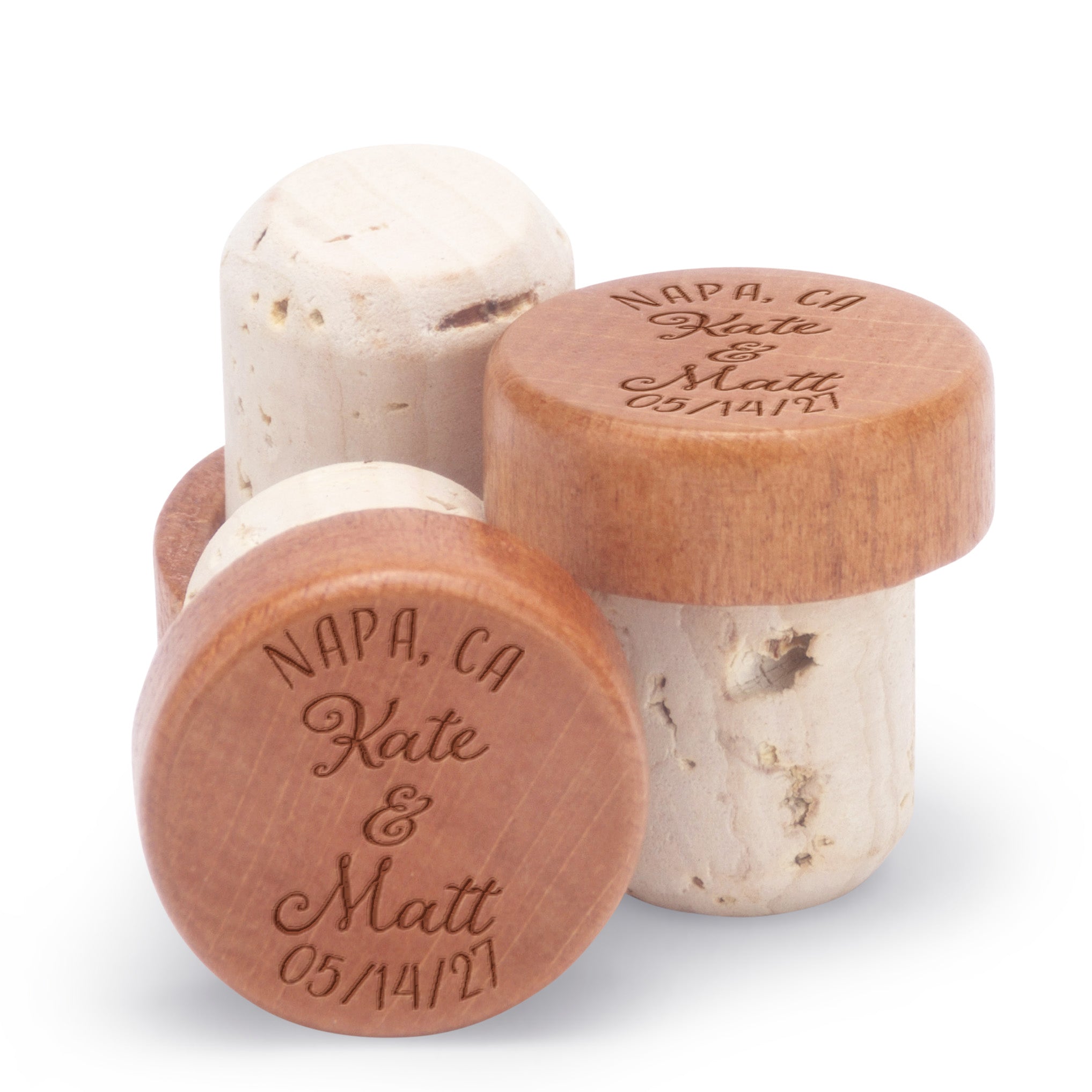 Custom bottle stoppers personalized with a couple's names and the name of a location.