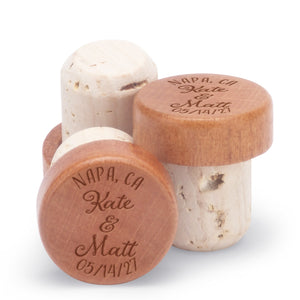 Custom bottle stoppers personalized with a couple's names and the name of a location.