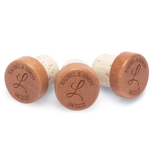 Custom champagne stoppers engraved with a couple's first names, last initial and date - a unique wedding favor.