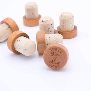 Wooden wine stoppers engraved with a couple's names and personalized with a location and custom date.